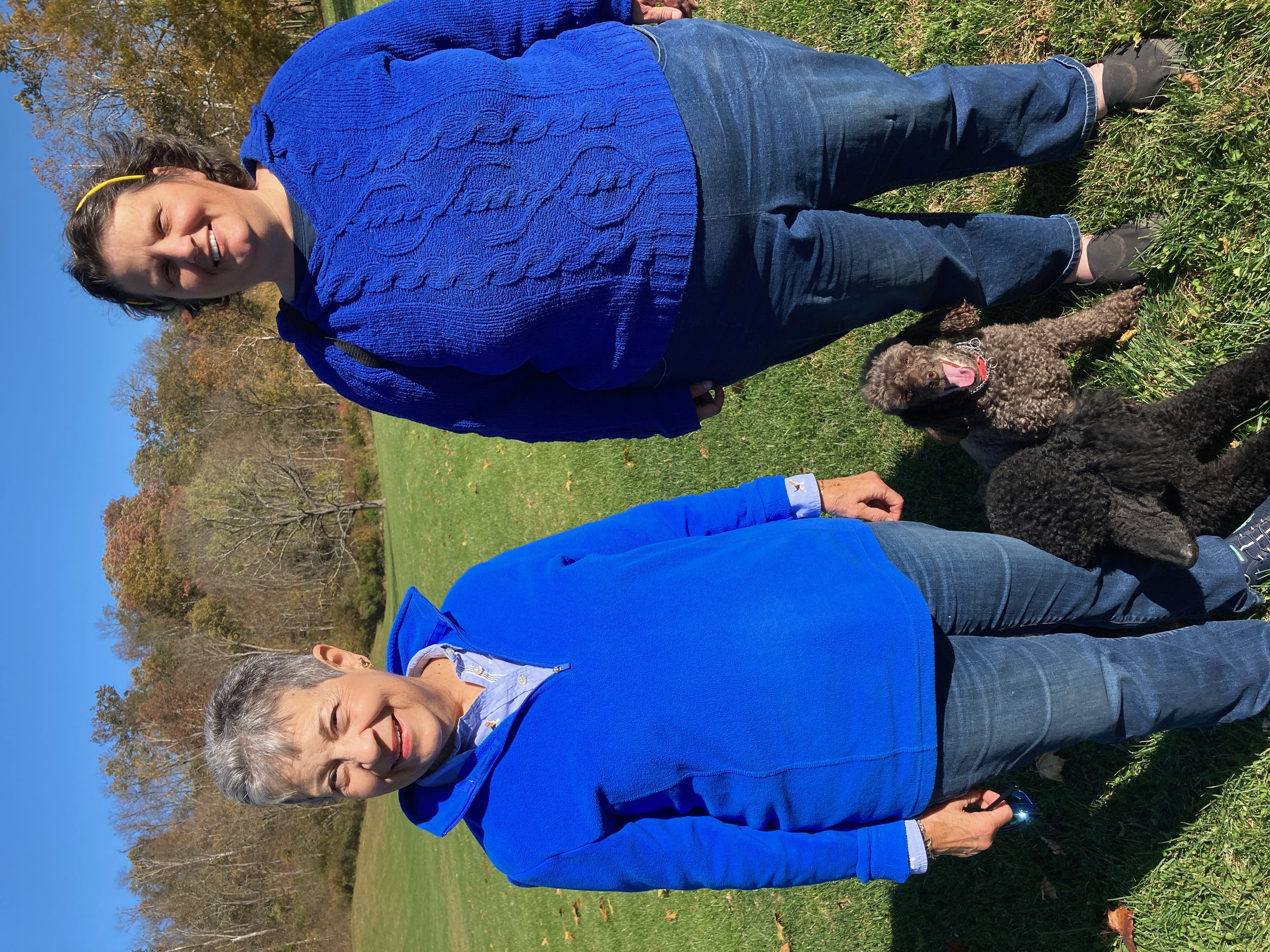 Elice and a friend with poodles in a fall field