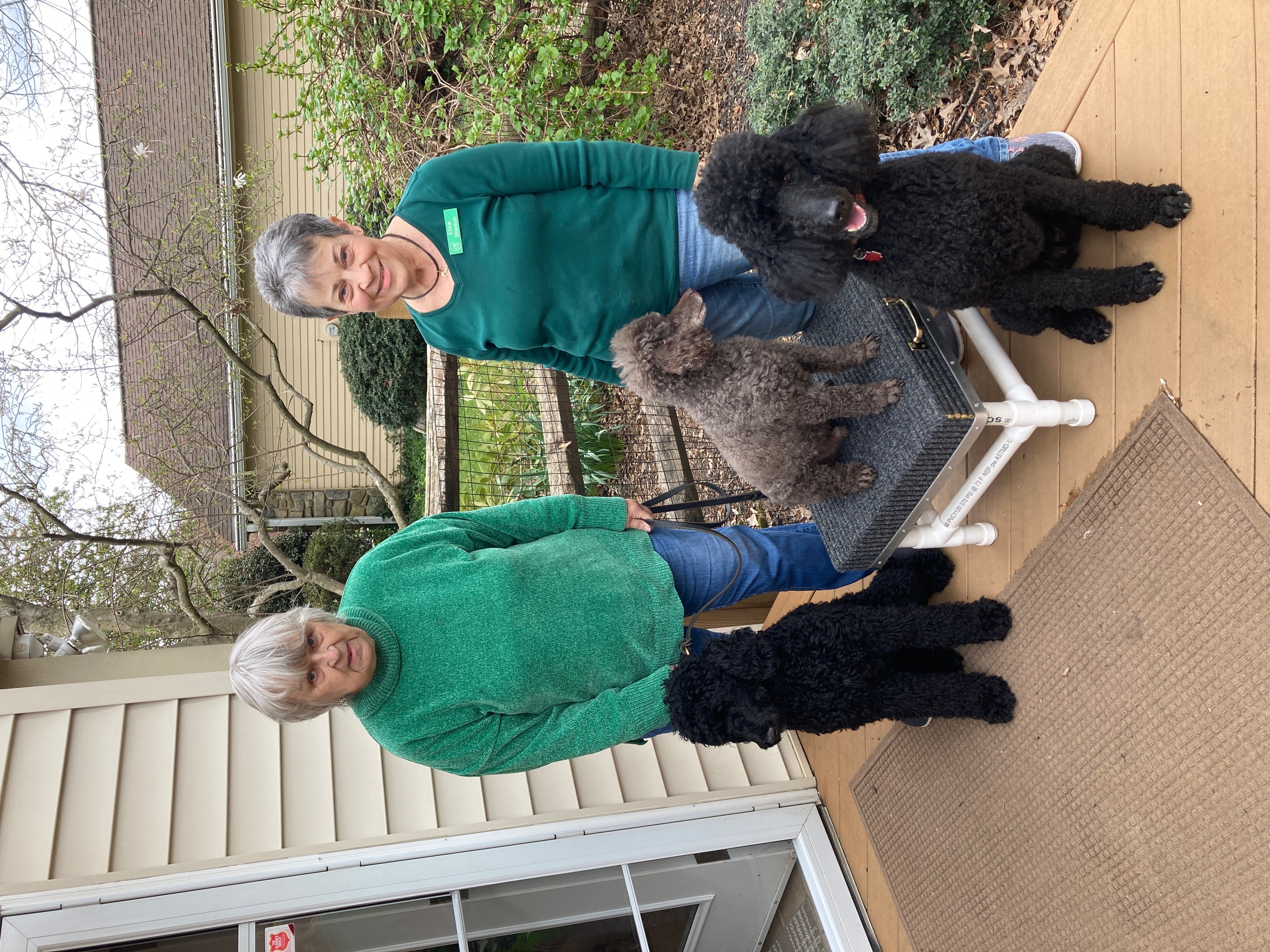 Elice and a friend with poodles on the porch