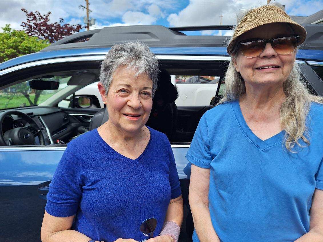 Elice and a friend by a car