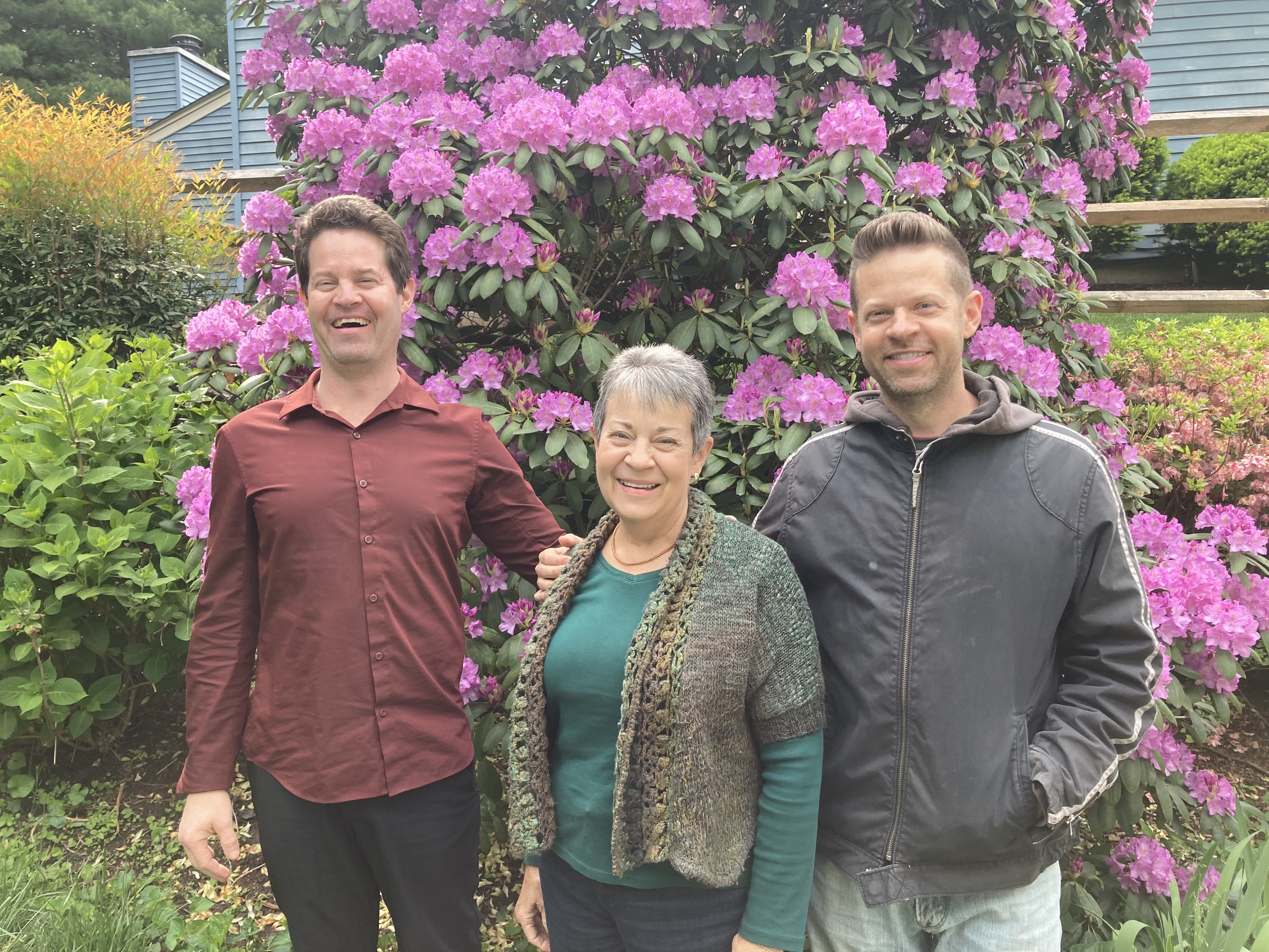 Elice with her two sons in front of rhododendron