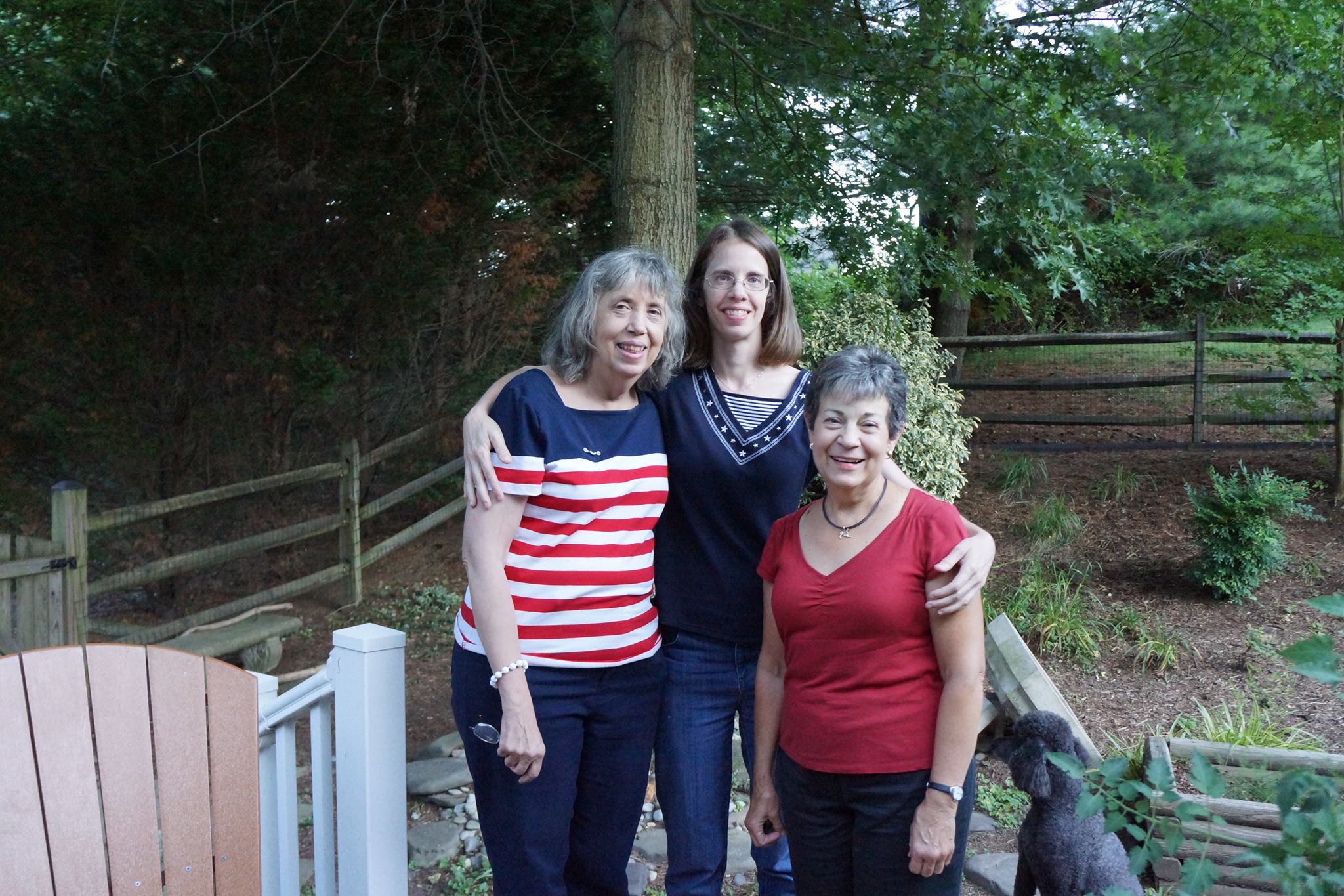 Three women with a poodle