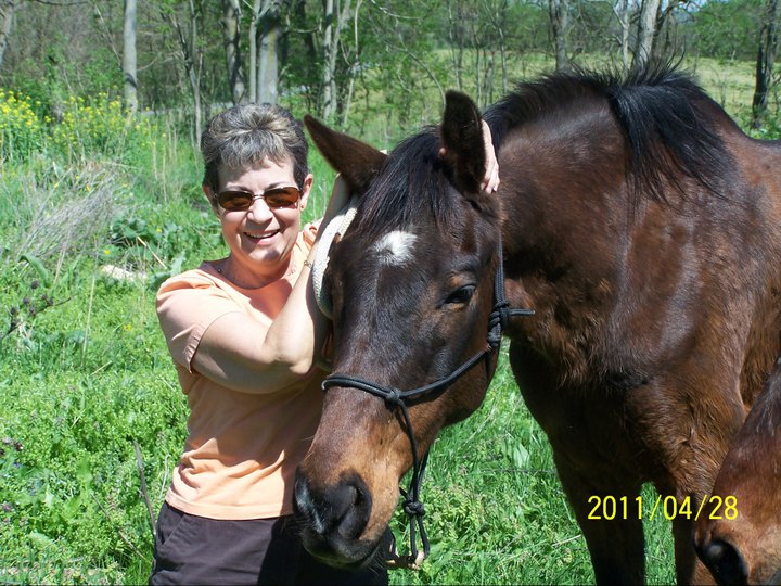 Elice with her bay horse in a field, April 2011